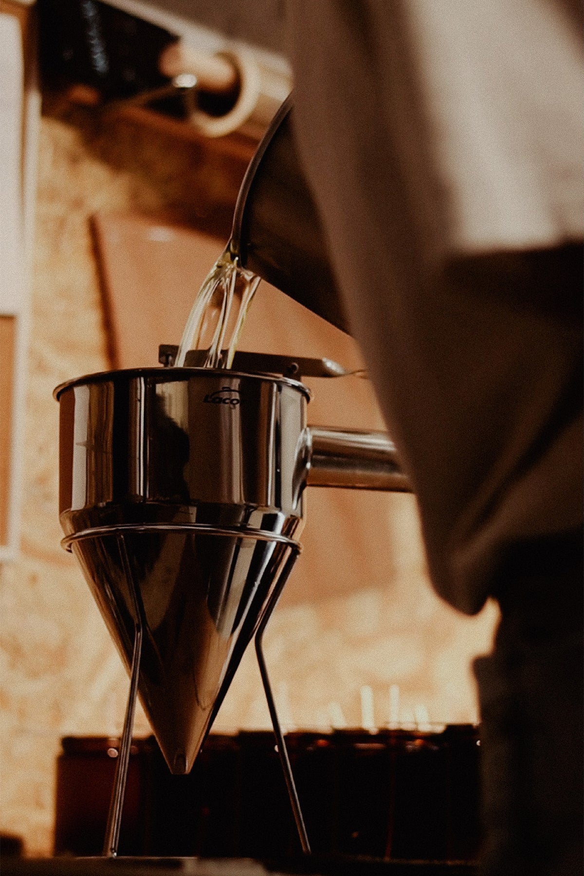 An Apothisoeurs candle being poured by hand